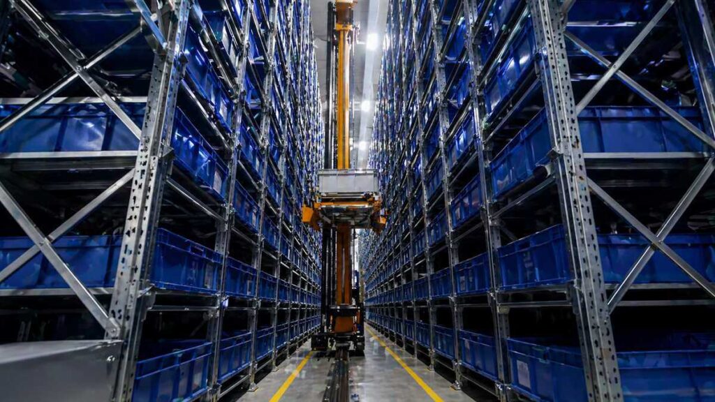 Mini load ASRS system with automated crane handling totes in high-bay warehouse