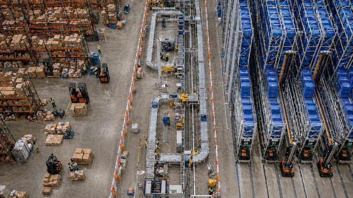 Phased warehouse automation approach combining manual and ASRS zones